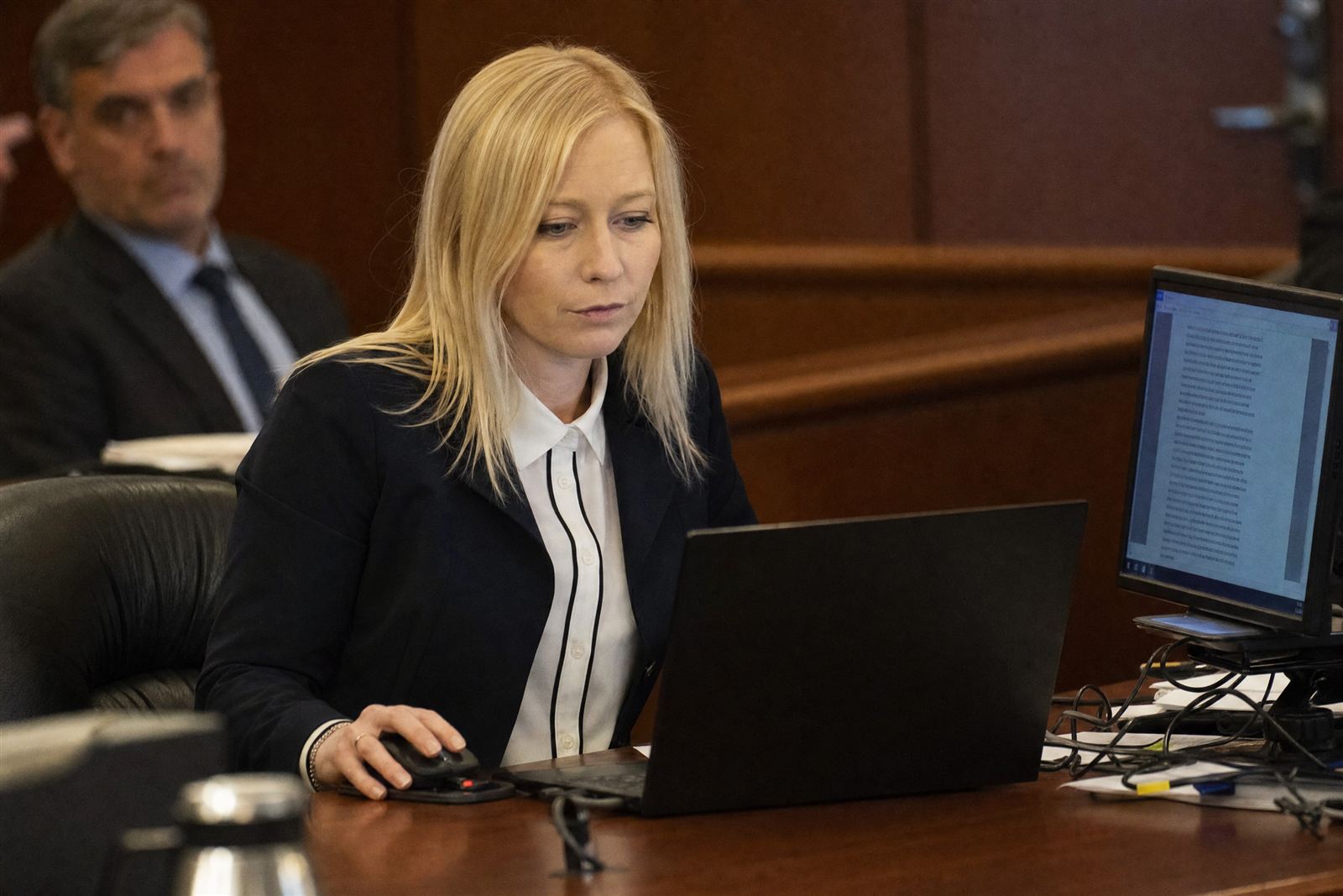 The specialist operating the trial presentation from the hot seat in a courtroom